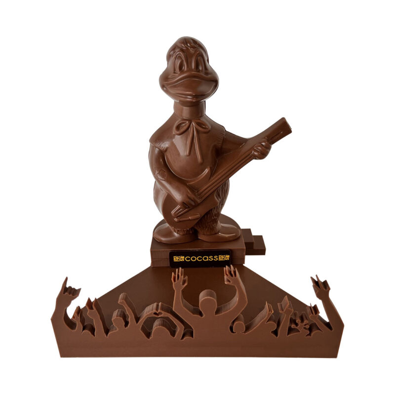 Canard bassiste, sa scène et son public en chocolat au lait, dans sa boite cadeau transparente.